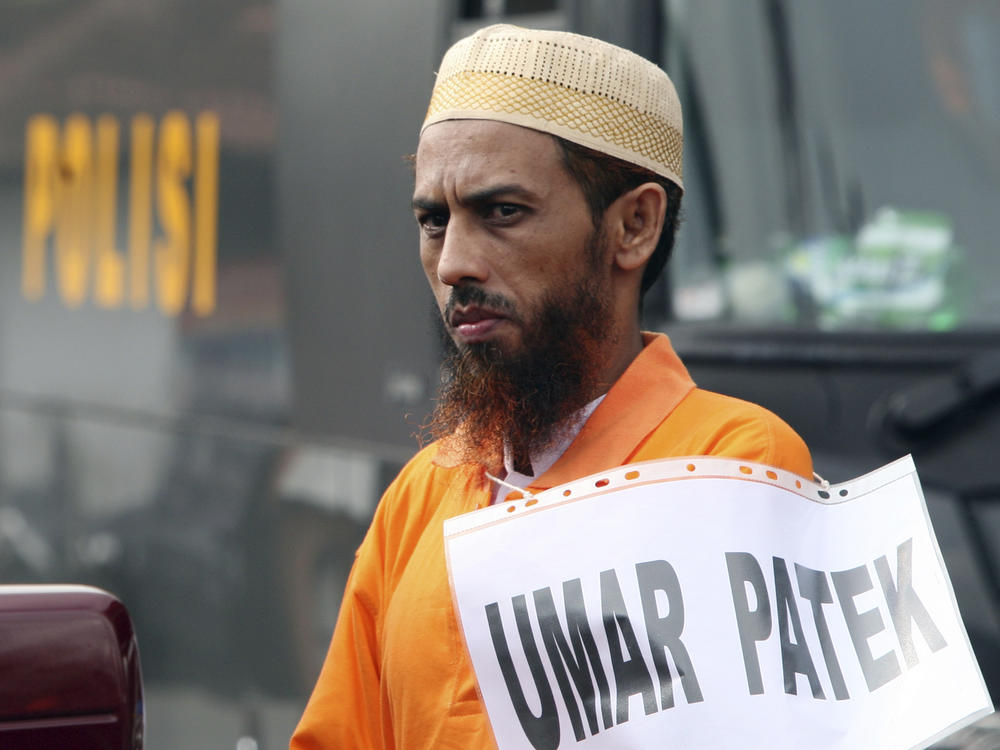 Convicted militant Umar Patek pauses during the police reenactment of the scenes leading to the 2002 Bali bombing, in Denpasar, Bali Indonesia, on Oct. 20, 2011.