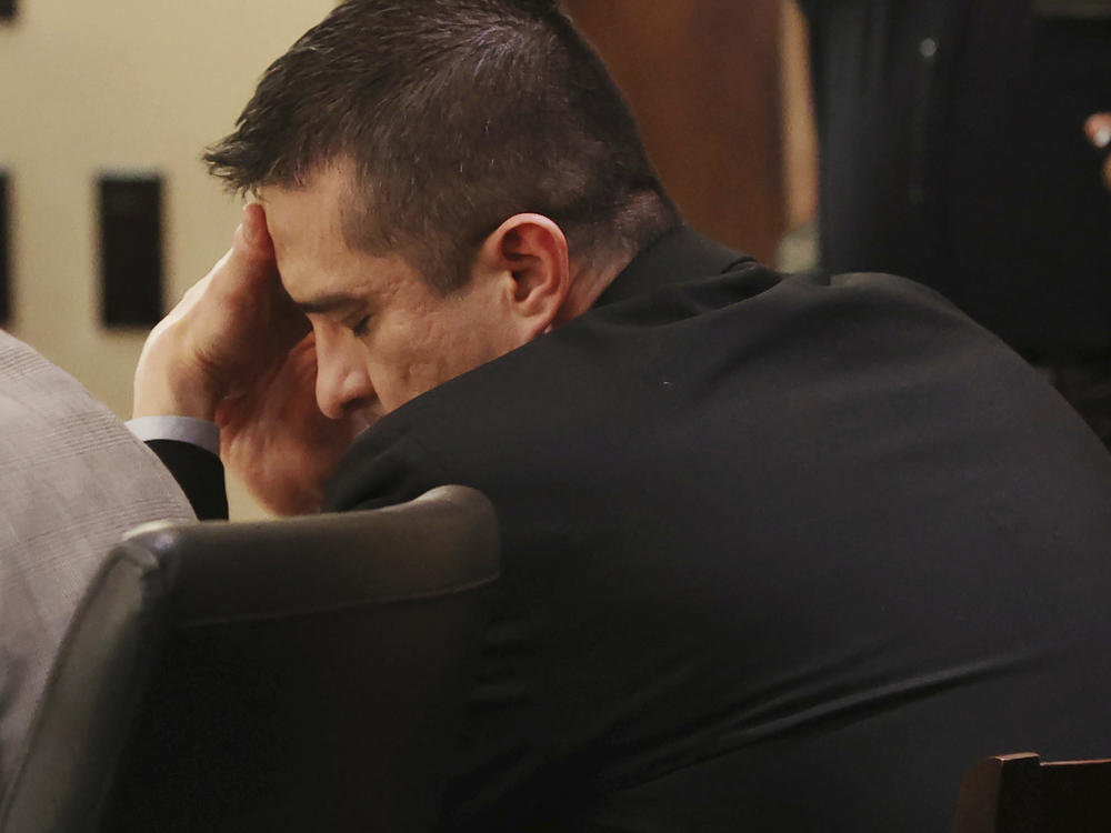 Former U.S. Border Patrol supervisor Juan David Ortiz reacts as recorder jail phone calls to his wife, Daniella, are played outside the presence of the jury during his capital murder trial in San Antonio, Texas, Tuesday, Dec. 6, 2022
