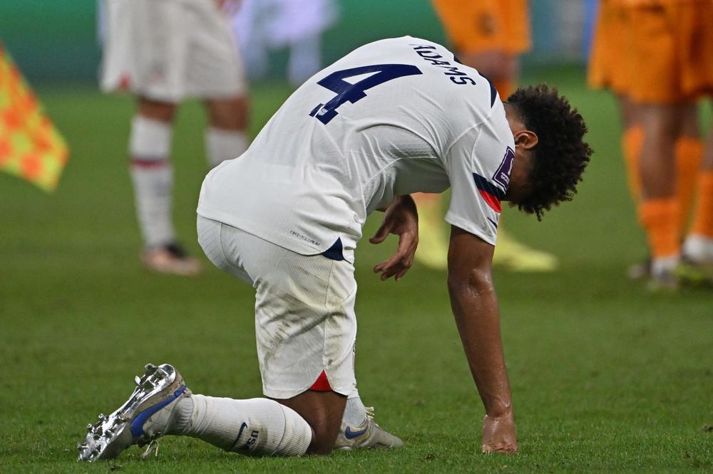 U.S. midfielder Tyler Adams  (No. 4) reacts after his team lost a 2022 World Cup Round of 16  match to the Netherlands on Saturday, Dec. 3, at Khalifa International Stadium in Doha, Qatar.