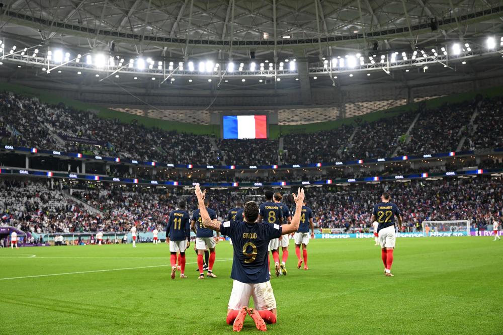 French forward Olivier Giroud (No. 9) celebrates after scoring his team's first goal during a 2022 World Cup Round of 16 match with Poland on Sunday, Dec. 4, at the Al-Thumama Stadium in Doha, Qatar.