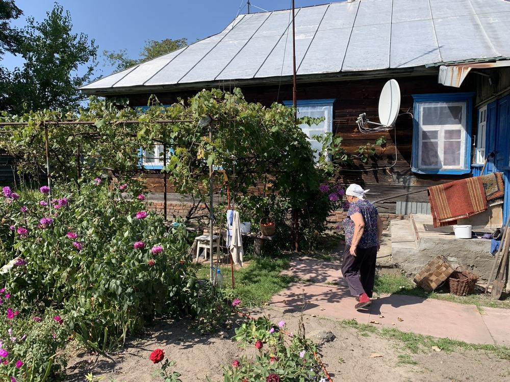 Sophia Arkadiyivna walks through her garden in Kupovate, Ukraine, on Aug. 29.