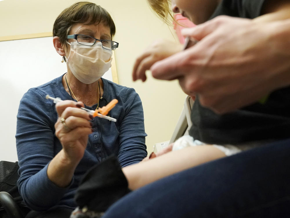 A nurse at a University of Washington Medical Center clinic in Seattle gives a Pfizer COVID-19 vaccine shot to a 20-month-old child on June 21.