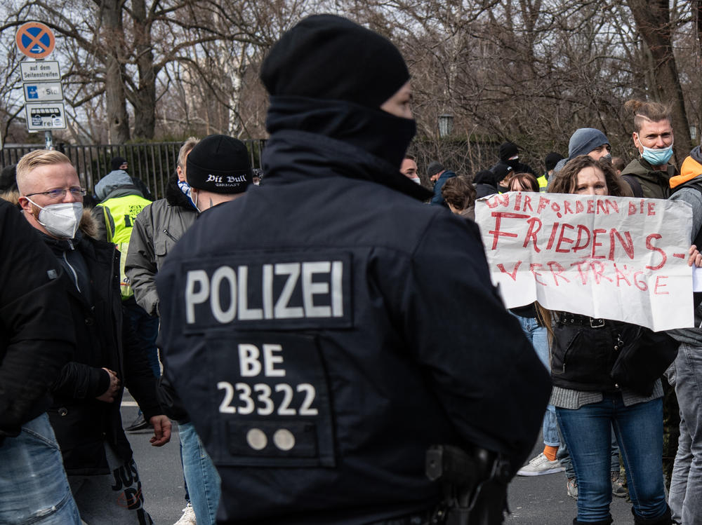 A police officer observes participants in the demonstration of right-wing extremists and Reichsburger on March 20, 2021 in Berlin. German right-wing extremists and 