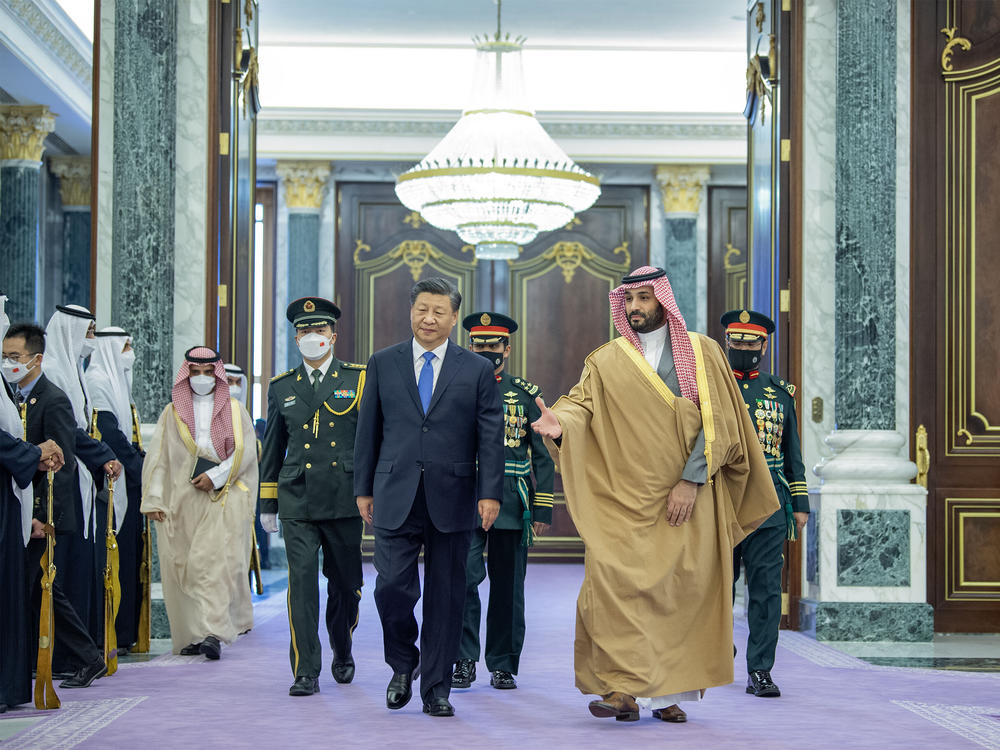 China's leader Xi Jinping (center) walks with Crown Prince of Saudi Arabia Mohammed bin Salman (right), following an official welcoming ceremony at the Palace of Yamamah in Riyadh, Saudi Arabia, on Thursday.