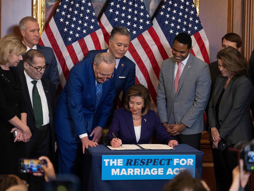 Speaker of the House Nancy Pelosi, center, (D-Calif.), surrounded by Senate and House members, participate in a bill enrollment ceremony for H.R.8404, the Respect For Marriage Act on Dec. 8.