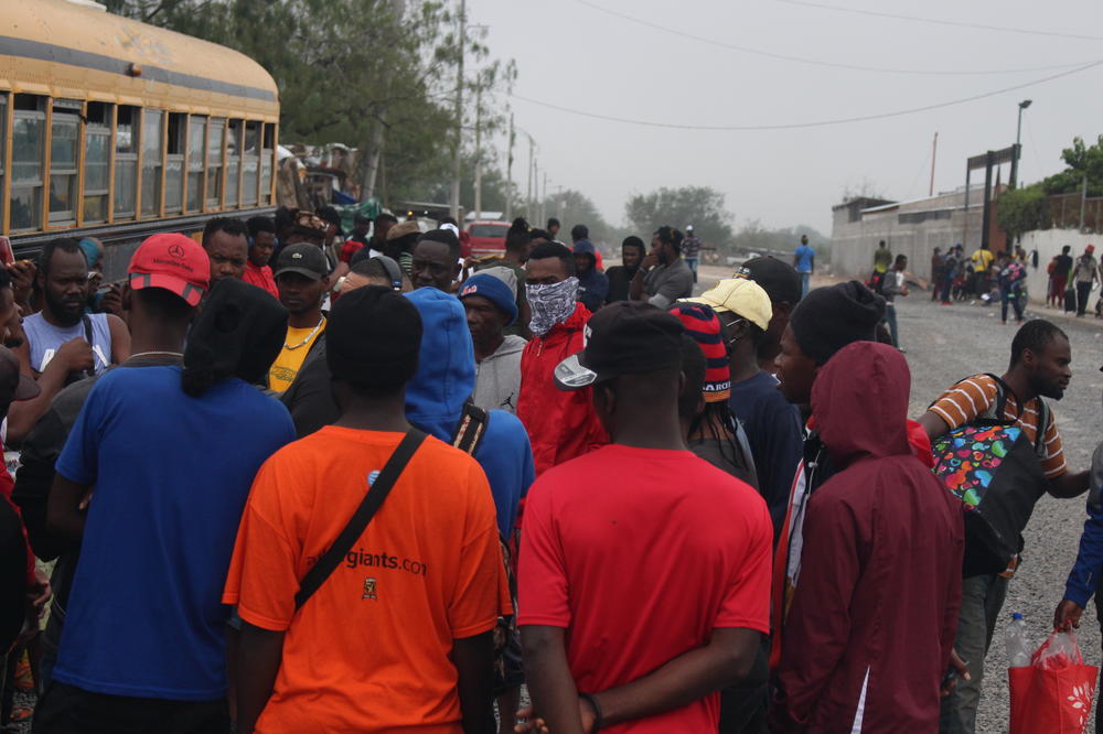 Haitian migrants gather around a reporter in Reynosa, Mexico earlier this week. There's a lot of confusion in the camp about Title 42, and whether it's ending or not.