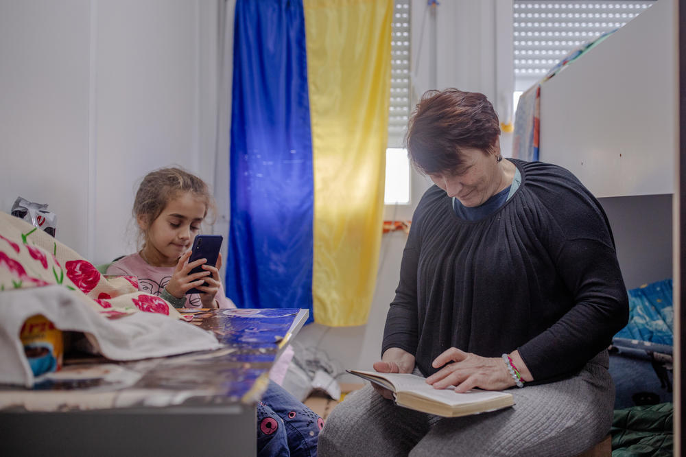 Nadia Povkh, 65, with her granddaughter, Dasha Povkh, 7, at the temporary housing center where they live in Borodianka on Sunday. Their apartment burned down amid Russian shelling in the spring.