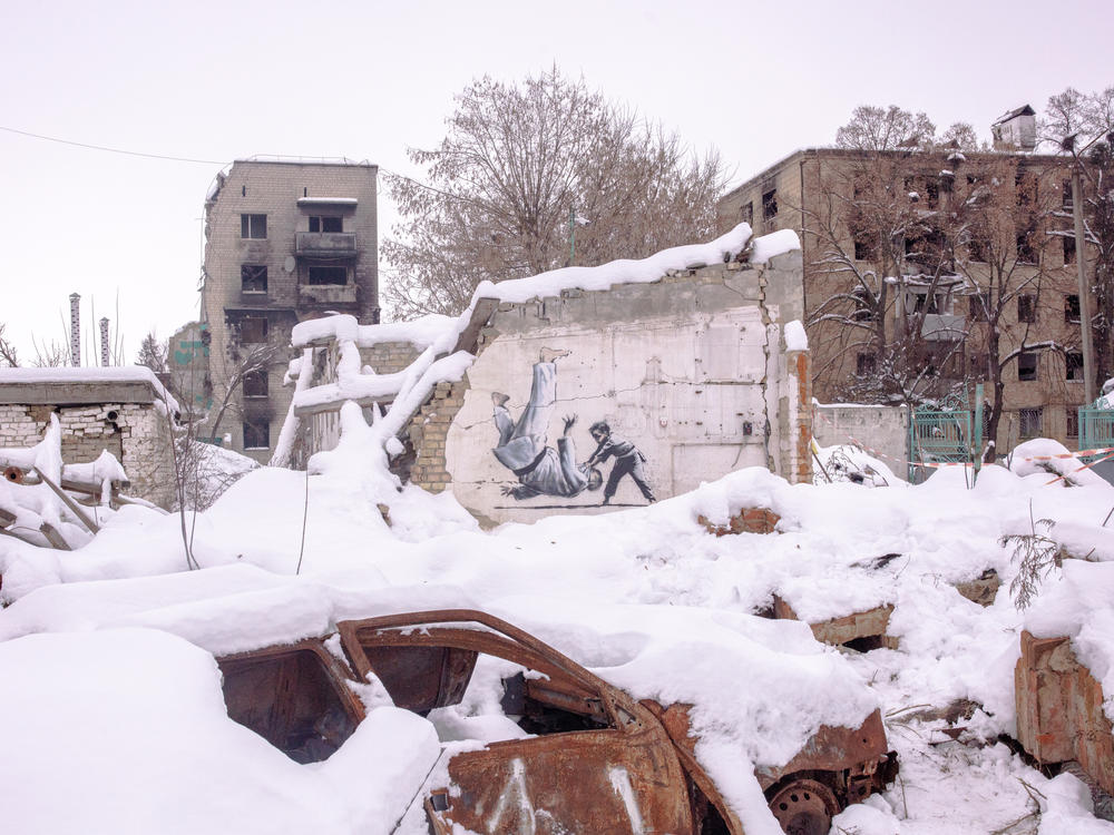 A painting by British street artist Banksy amidst destroyed buildings in Borodianka on Saturday. The image shows a young boy tossing a man to the floor. Both are in martial arts attire. The man is widely assumed to be Russian leader Vladimir Putin, a judo enthusiast.