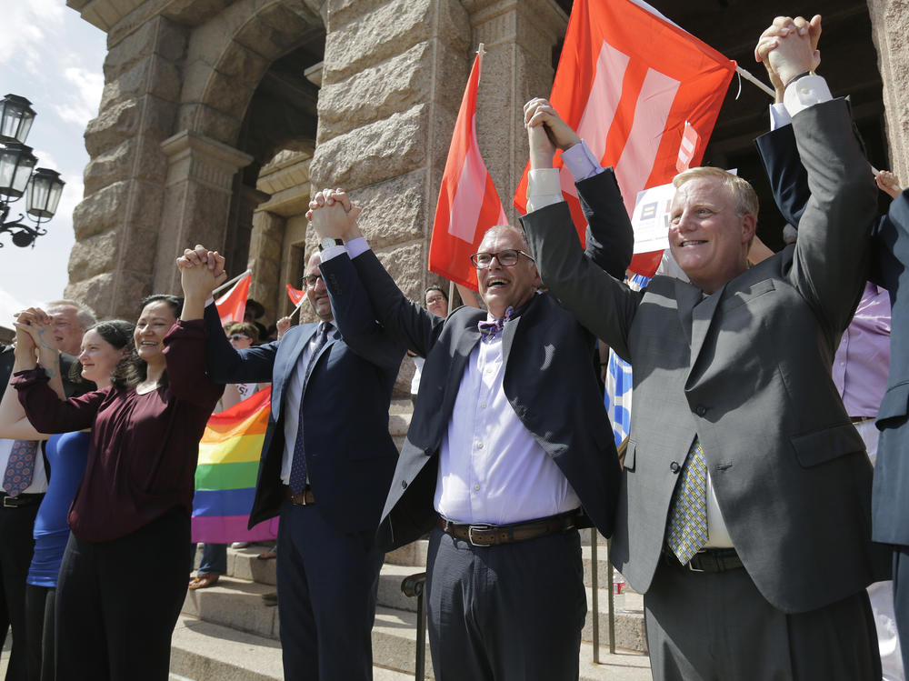 Jim Obergefell, the named plaintiff in the Obergefell v. Hodges Supreme Court case that legalized same sex marriage nationwide, center, stands on the steps of the Texas Capitol, Monday, June 29, 2015, in Austin, Texas.