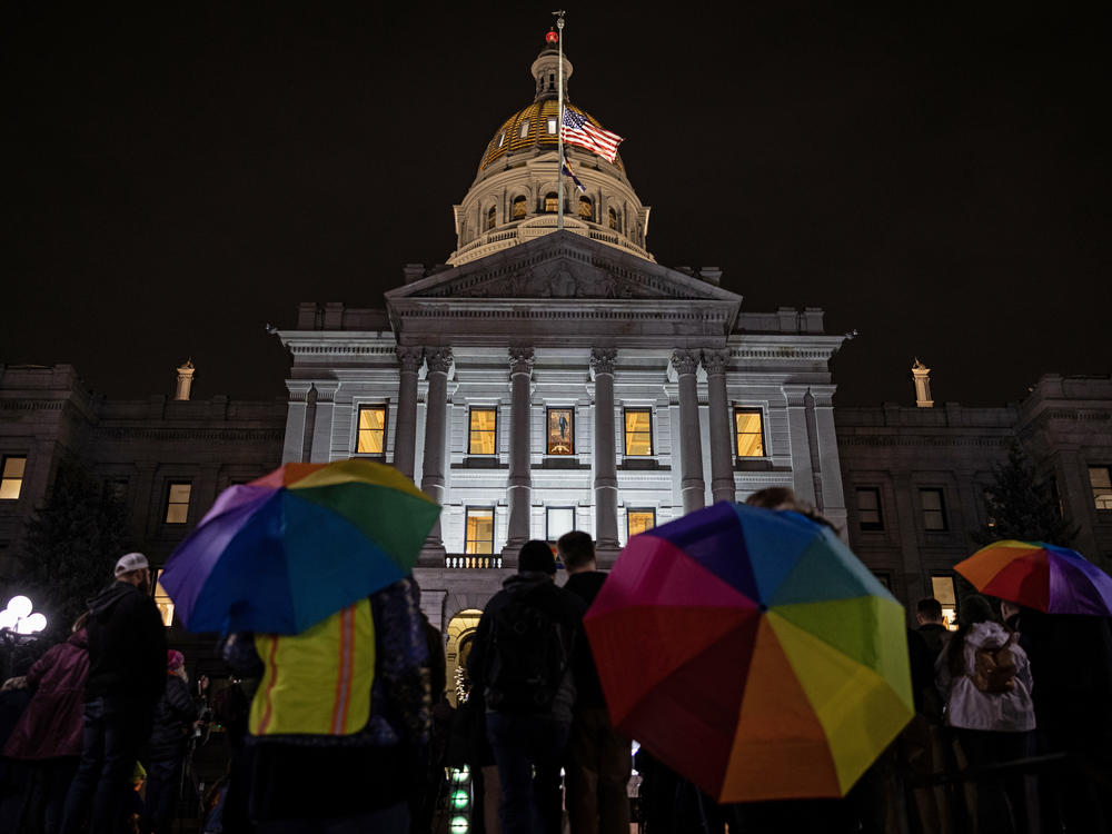 Mourners hold a candlelight vigil outside the State Capitol in Denver on Nov. 23 to honor the victims of the Club Q shooting. The state's red flag laws have come under question following news that a criminal case involving the main suspect was dropped just four months earlier.