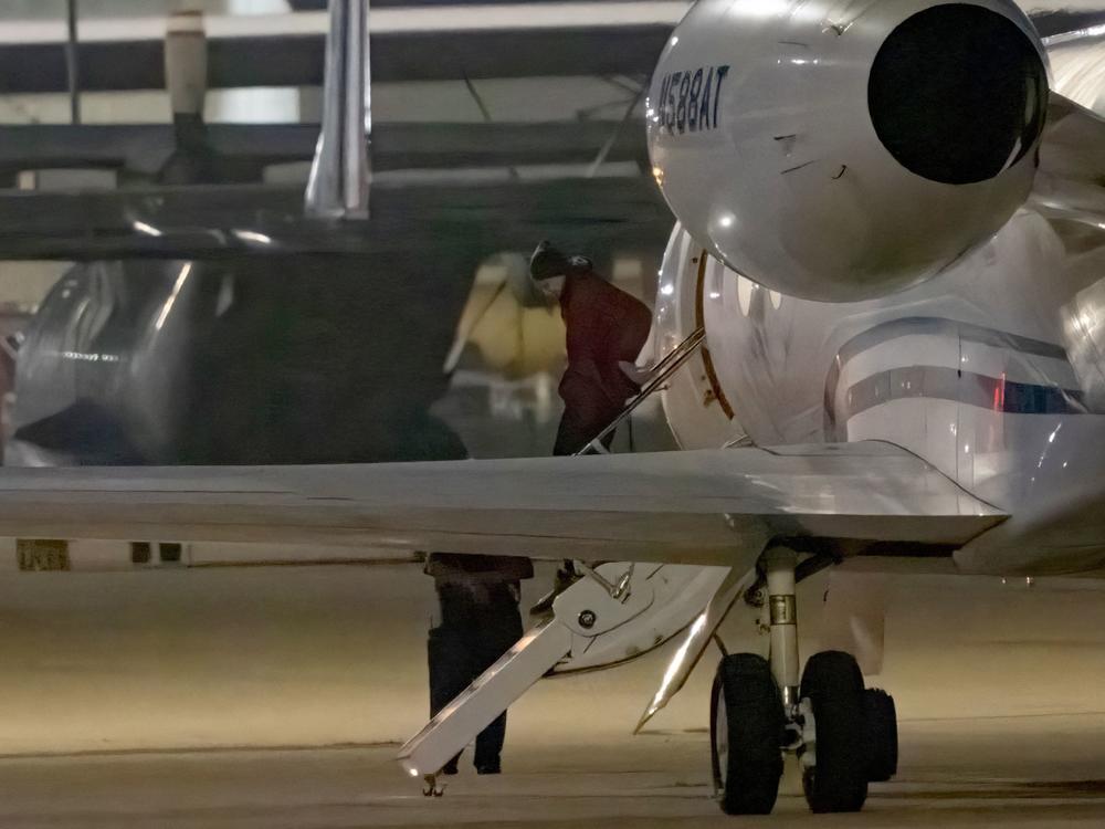 American basketball star Brittney Griner gets out of a plane after landing in San Antonio on Friday.