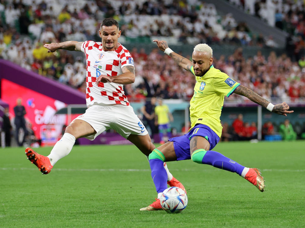 Neymar of Brazil takes a shot against Dejan Lovren of Croatia during the FIFA World Cup 2022 quarterfinal match between Croatia and Brazil at Education City Stadium on December 09, 2022 in Al Rayyan, Qatar.