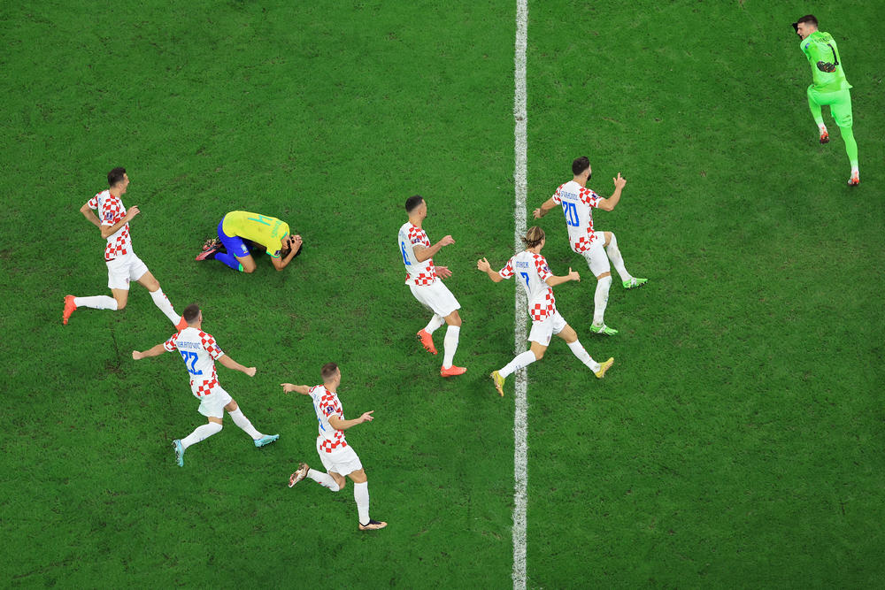 Croatia players celebrate their win via a penalty shootout as Marquinhos of Brazil reacts to missing his kick during the World Cup quarterfinal match between Croatia and Brazil.