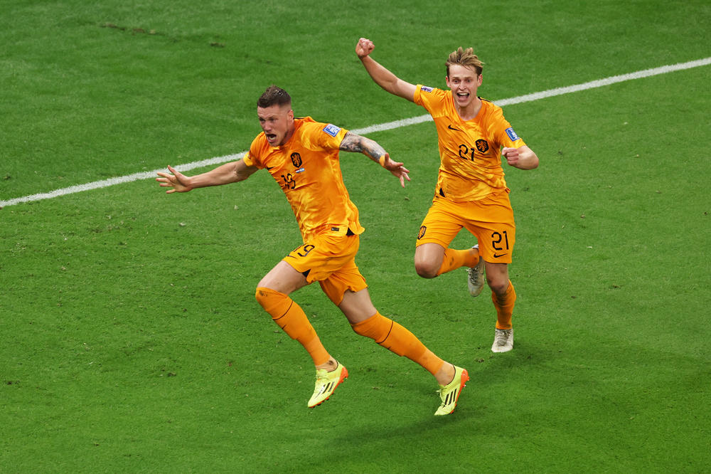 Wout Weghorst (L) of Netherlands celebrates with teammate Frenkie de Jong after scoring the team's second goal during the World Cup quarterfinal match against Argentina on December 09, 2022.