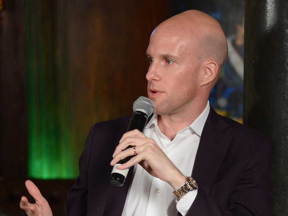 In this file photo, sportswriter Grant Wahl speaks during a panel discussion in New York in 2014. He died Friday in Qatar while covering the Argentina-Netherlands World Cup quarterfinal.