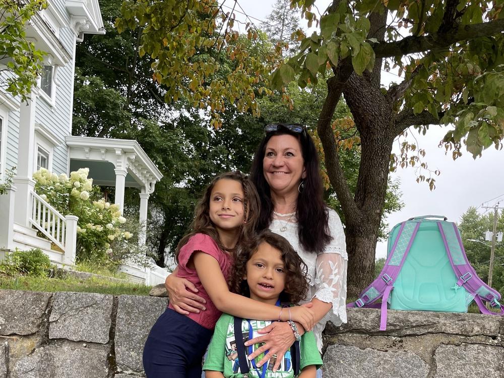 Jennifer Hensel waits for the school bus with her 8-year-old daughter, Imogen, and her 6-year-old son, Owen, on the first day of school this year. They share hugs, kisses, excitement and still some anxiety 10 years after the shooting.