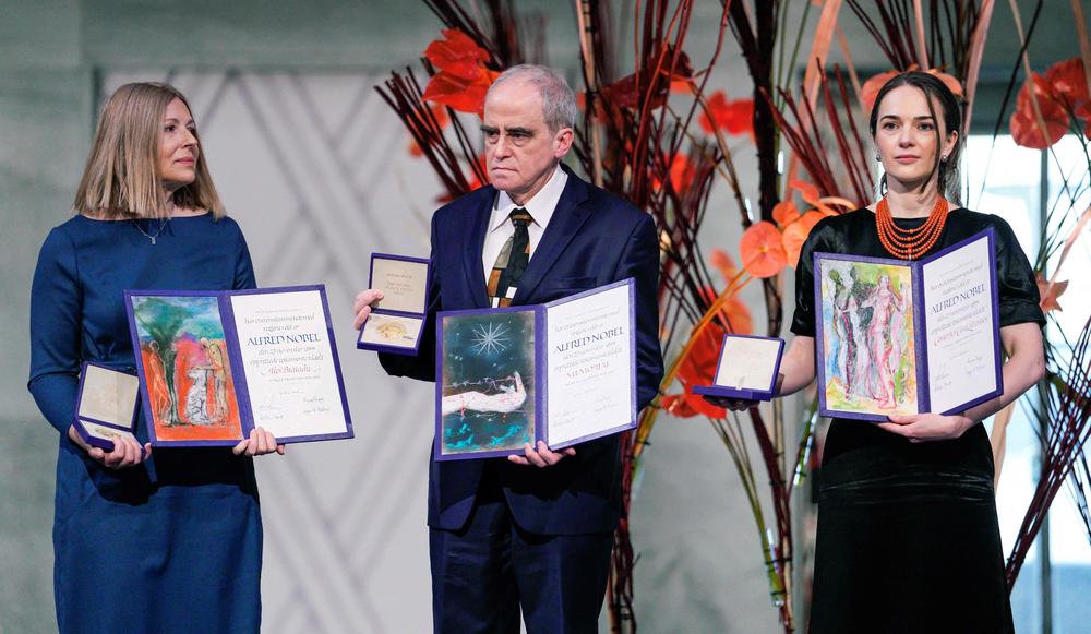 Natalia Pinchuk, left, on behalf of her husband, the jailed Belarusian activist Ales Bialiatski; Yan Rachinsky center, on behalf of the group Memorial; and head of the Ukrainian Center for Civil Liberties Oleksandra Matviichuk pose with their Nobel Peace Prizes in Oslo, Norway, on Saturday.