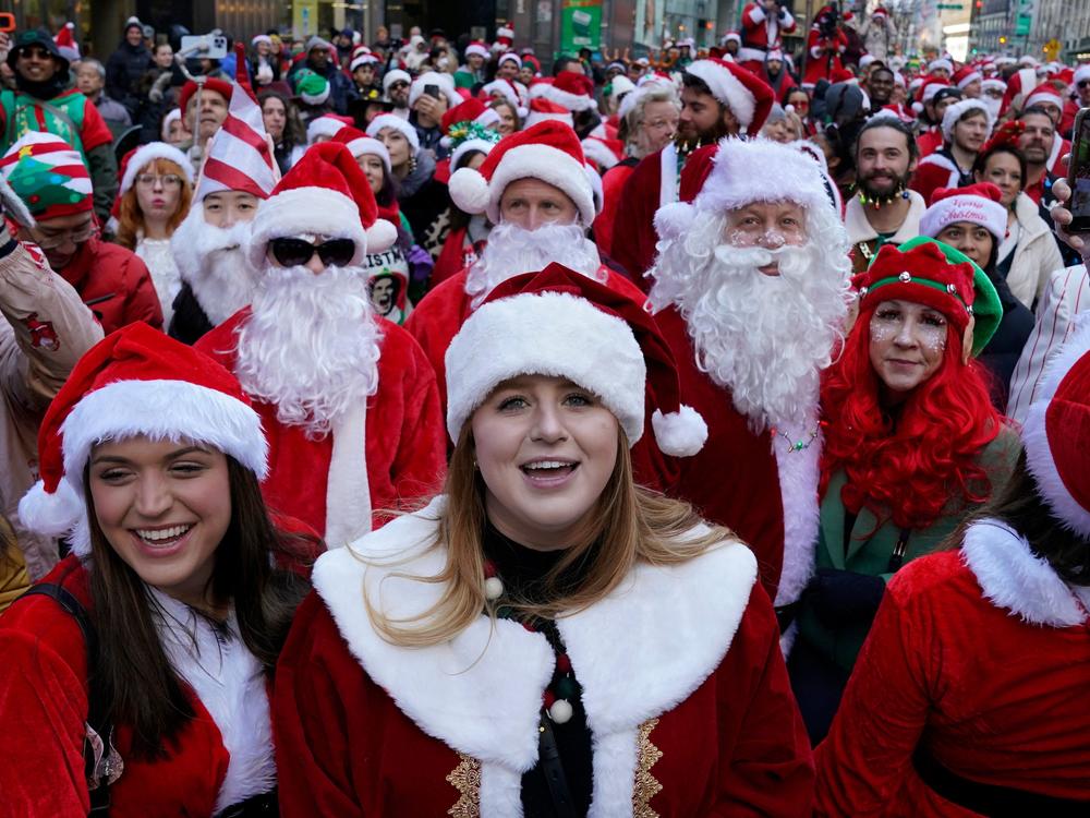 Revellers gather in Times Square for the start SantaCon in New York City on Saturday.