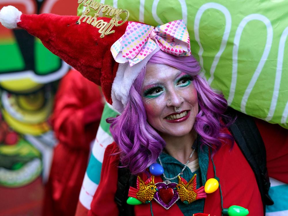 SantaCon participants gather in Times Square for the start of the 2022 SantaCon NYC on Saturday.