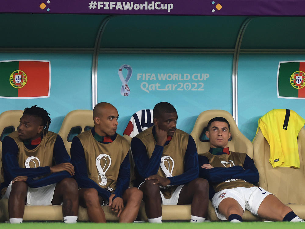 Cristiano Ronaldo of Portugal (R) reacts on the bench during the 2022 World Cup quarterfinal match against Morocco on December 10, 2022 in Doha, Qatar.