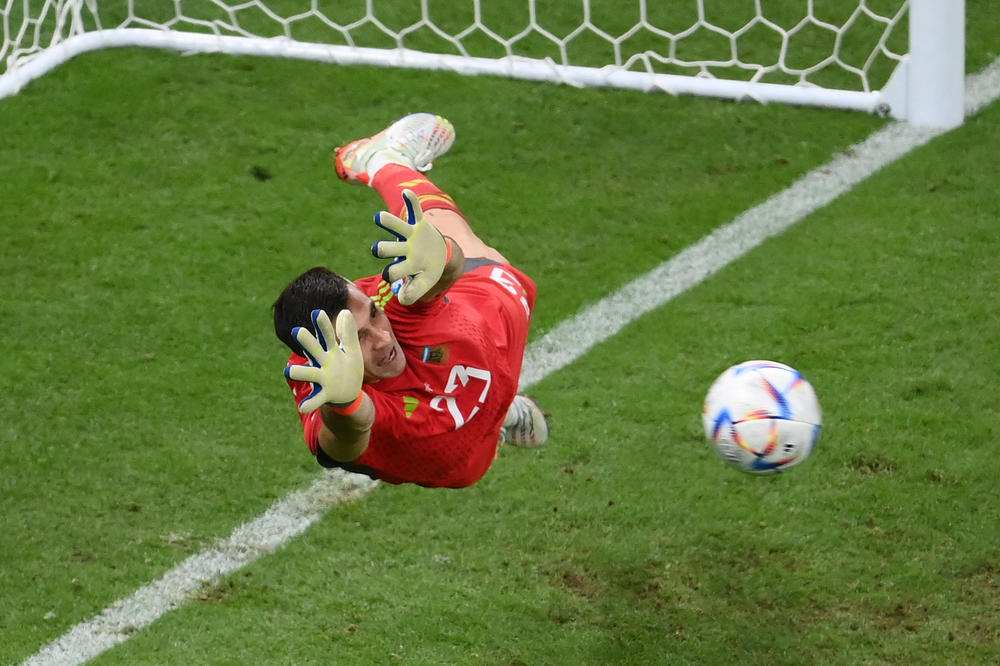 Argentina's goalkeeper, Emiliano Martinez (No. 23), saves a shot by Netherlands' defender Virgil van Dijk (No. 4) in a penalty shoot-out during a 2022 World Cup quarterfinal match on Friday, Dec. 9, at the Lusail Stadium, north of Doha, Qatar.