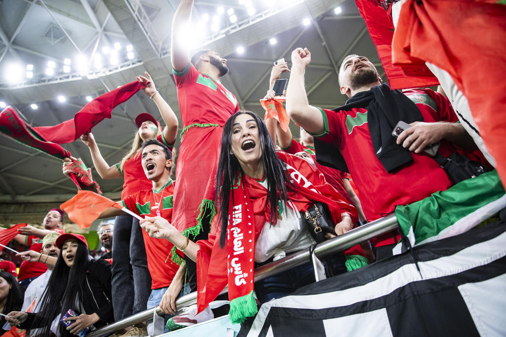 Fans from Morocco cheer for victory in the stands after the quarterfinal between Morocco and Portugal at Al-Thumama stadium.