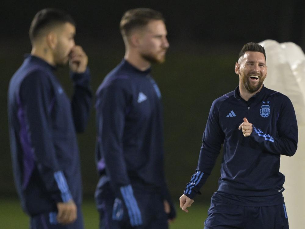 Argentina forward Lionel Messi (R) laughs during a training session at Qatar University in Doha on Dec. 12, 2022, a day before the Argentina's World Cup semifinal match against Croatia.