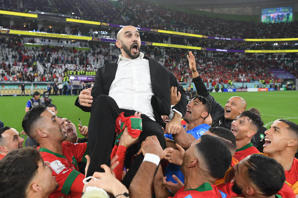 Morocco's players hoisted their coach, Walid Regragui, after winning their quarterfinal match against Spain at Al Thumama Stadium on Saturday in Doha, Qatar.