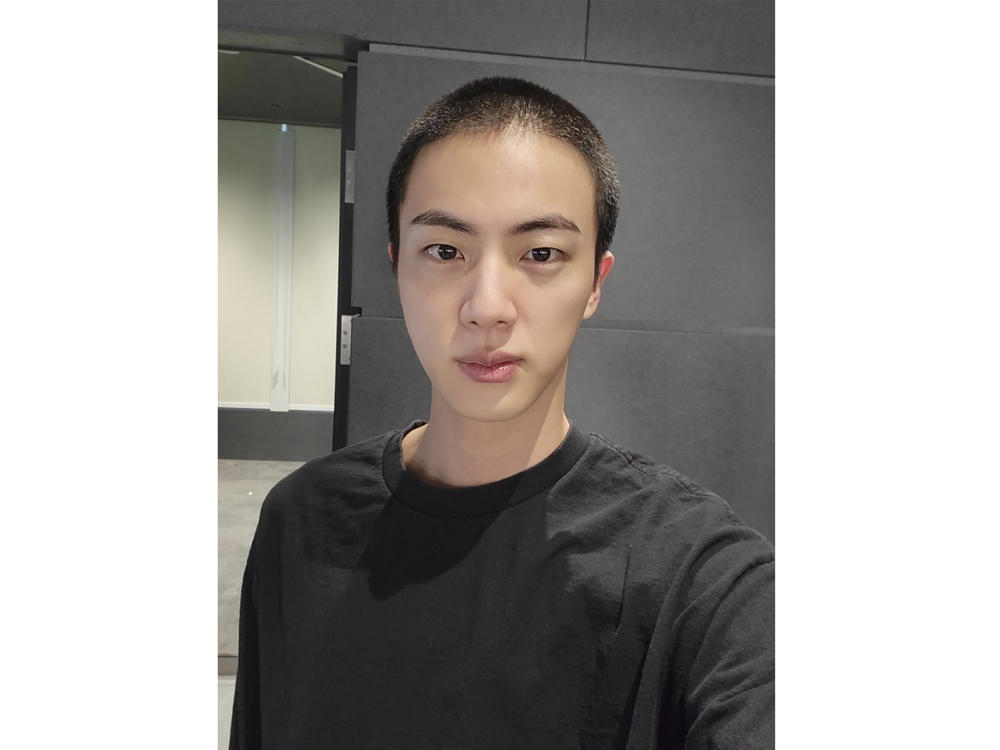 In this photo provided by Weverse, Jin of K-pop band BTS shows off freshly shaved hair on the K-pop social media platform Weverse, which was uploaded on Dec. 11, 2022, ahead of his upcoming military conscription.