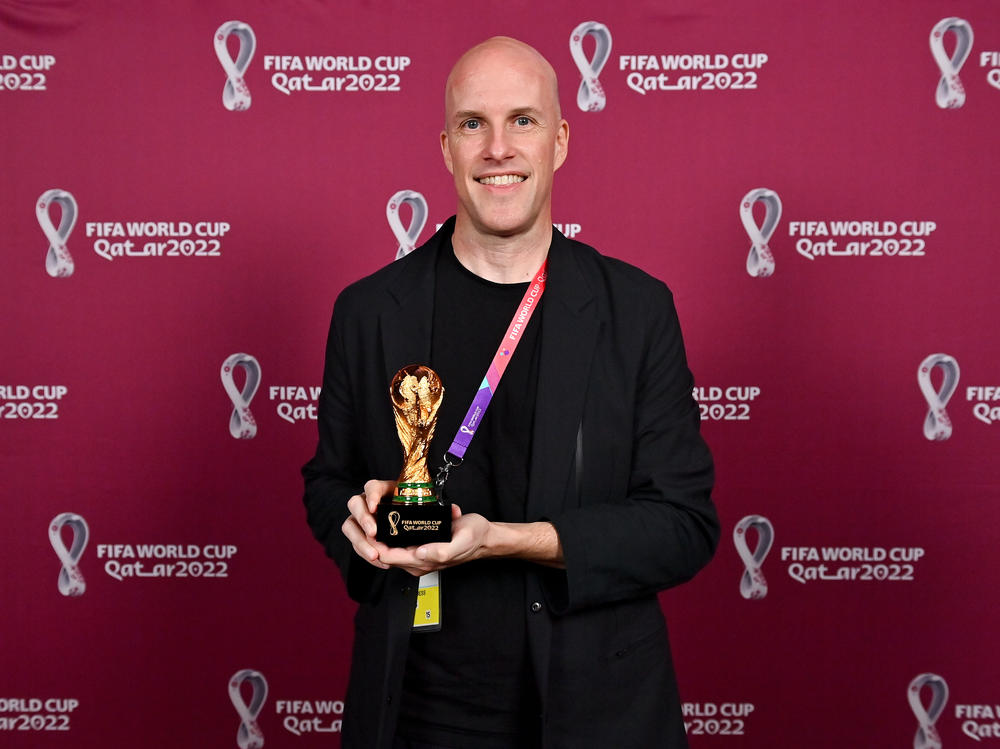 Grant Wahl with a World Cup replica trophy, in recognition of his achievement covering 8 or more FIFA World Cups, during a ceremony at the Main Media Centre on Nov. 29 in Doha, Qatar.