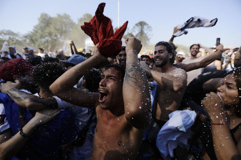 Argentina's fans celebrate in Buenos Aires' Francisco Seeber square while watching a live broadcast of the 2022 World Cup semifinal match between Argentina and Croatia on Tuesday, Dec. 13.