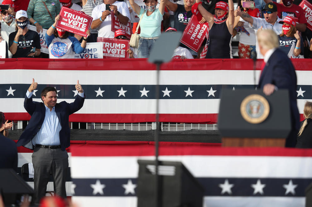 Florida Republican Gov. Ron DeSantis gives two thumbs up to former President Donald Trump as Trump speaks during his campaign event on Oct. 23, 2020 in The Villages, Fla. DeSantis is expected to announce he will run for president in 2024 against Trump.