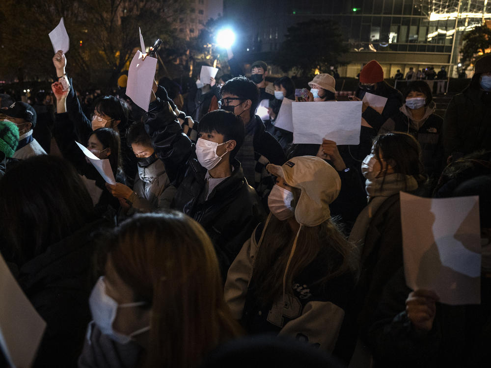 Protesters hold up a white piece of paper against censorship during a protest against China's strict zero COVID measures on November 27, 2022 in Beijing.