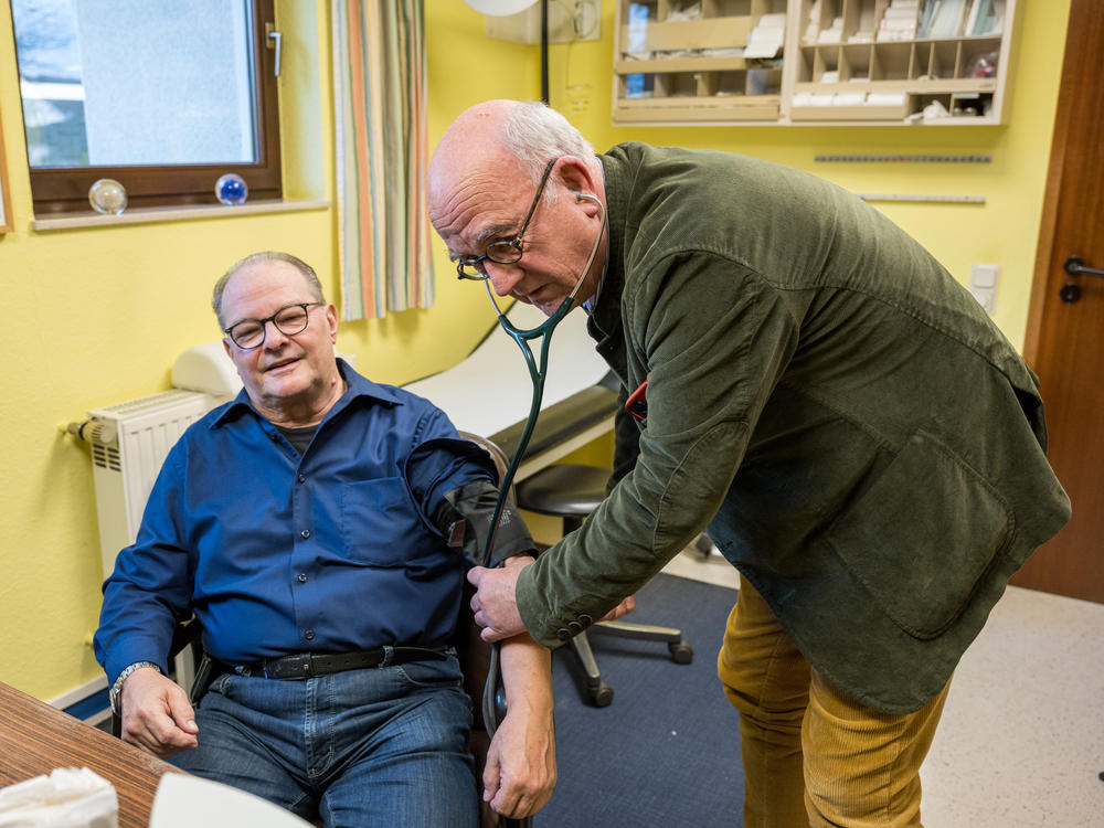 Dr. Eckart Rolshoven examines a patient at his clinic in Püttlingen, a small town in Germany's Saarland region. Although Germany has a largely private health care system, patients pay nothing out-of-pocket when they come to see him.