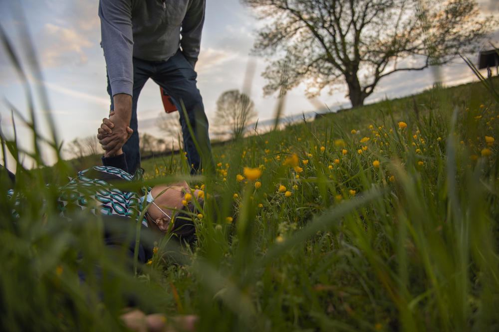 Maansi's father, Bhuwan Srivastava, lifts her mother, Shubhika Srivastava, out of the grass at the park near their home in Wilmington, Del.