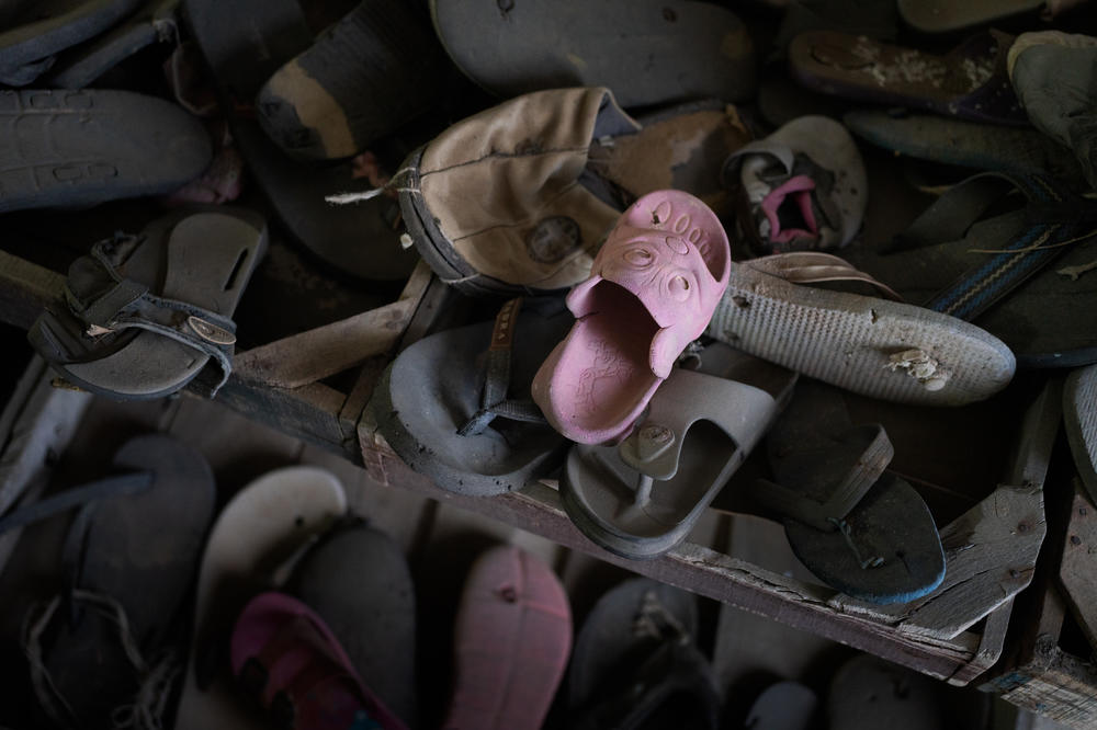 A small pink slipper sits atop a pile of shoes collected from the shores of the Mediterranean in Zarzis, Tunisia. The museum housing the shoes honors the migrants who die crossing the sea.