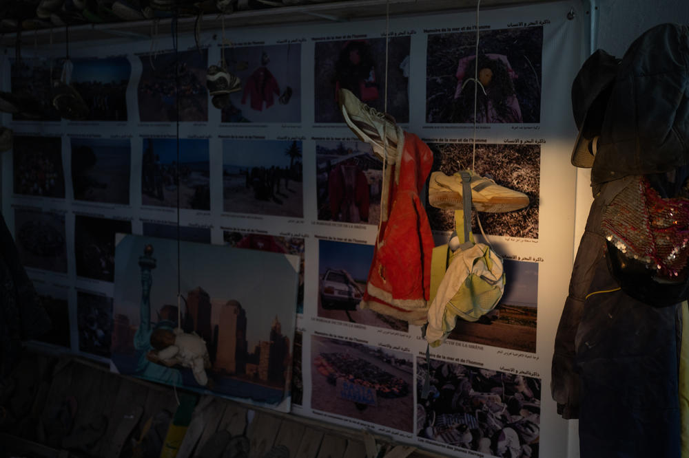 A little girl's red coat hangs in the museum.