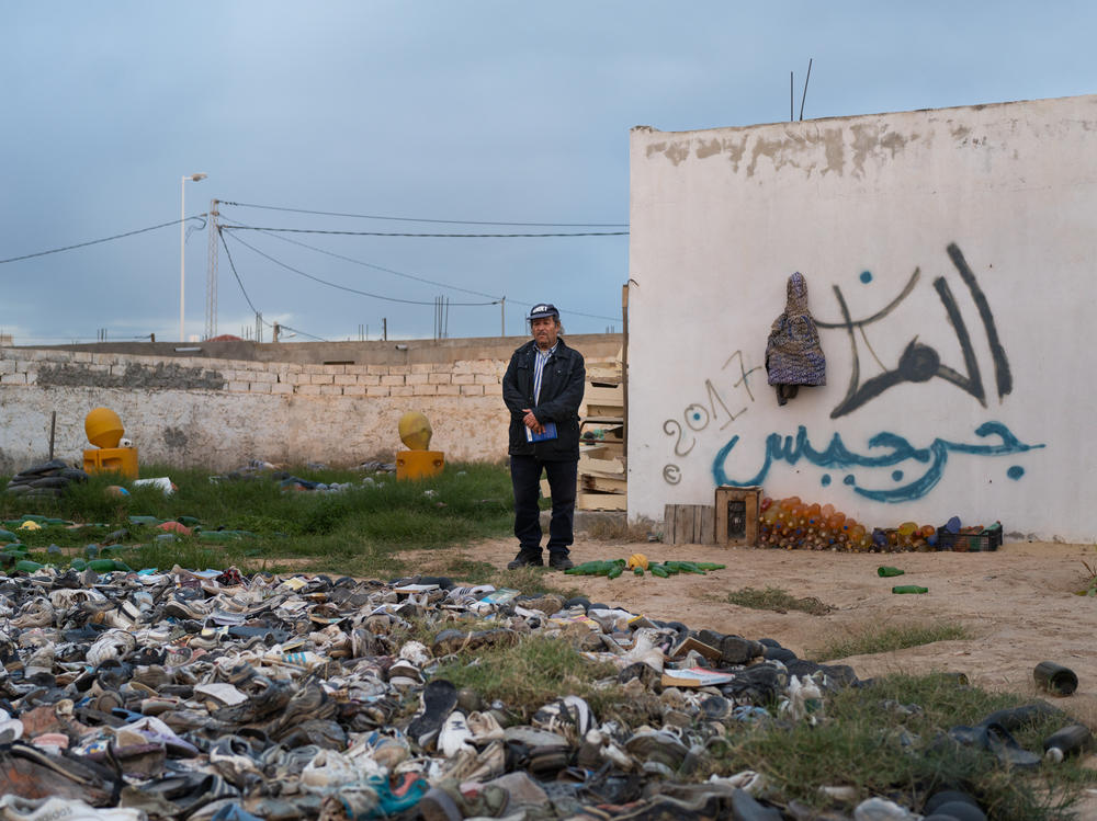 Mohsen Lihidheb stands in the backyard of his museum that is filled with things that he's collected after the waves brought them ashore in Zarzis, Tunisia.