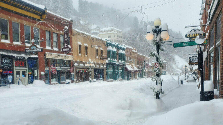 An image provided by Historic Bullock Hotel Manager Vicki Weekly shows snow piled in front of the hotel Tuesday in Deadwood, S.D.