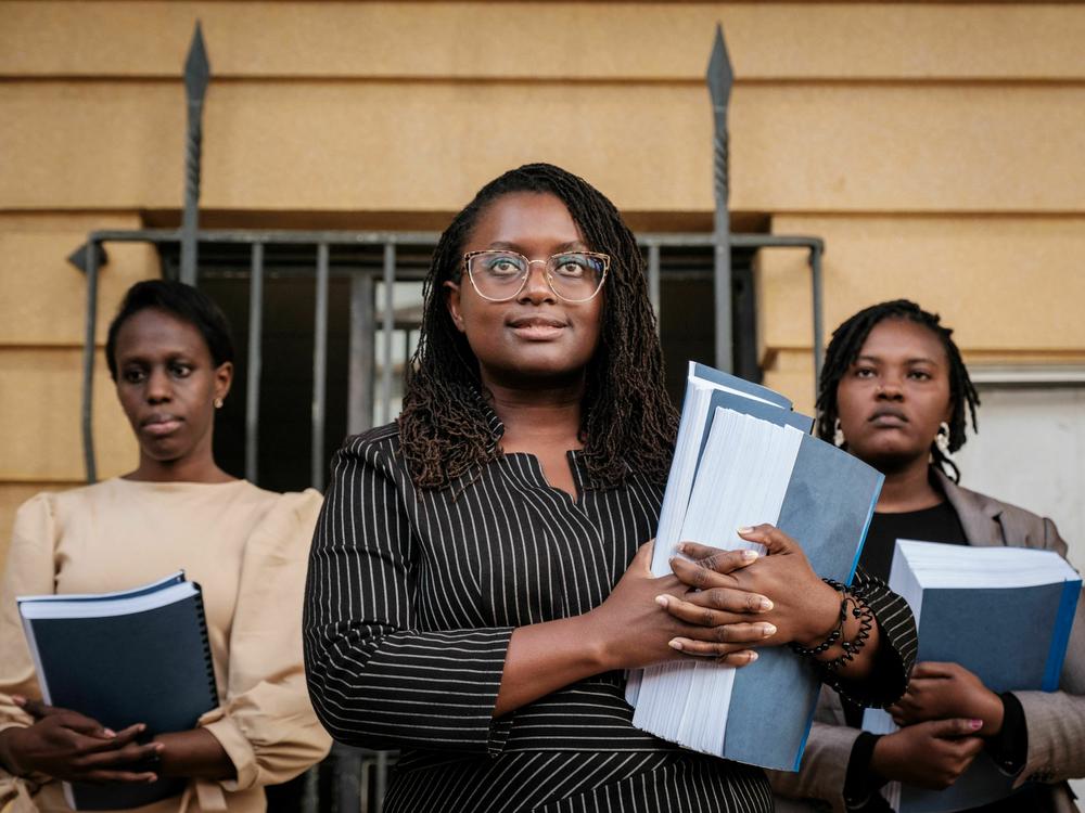 Kenyan lawyer Mercy Mutemi (center) speaks to the media in Nairobi on Dec. 14 after filing a lawsuit against Meta accusing Facebook's parent company of fanning violence and hate speech.