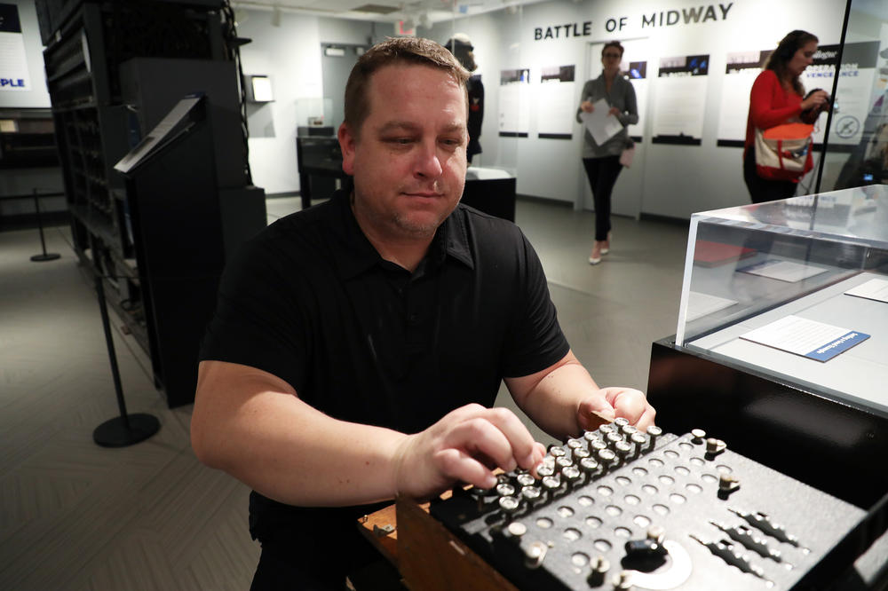 National Cryptologic Museum Director Vince Houghton demonstrates how to use a captured German Enigma machine, a World War II era encryption device.