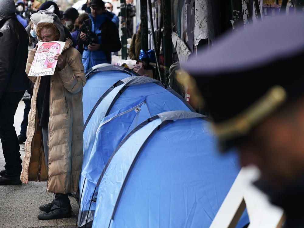 An unhoused woman protests as police prepare to break up a small homeless encampment in New York earlier this year. Most individuals experiencing homelessness are now on the streets instead of in shelters, a shift that has raised visibility of the crisis but also has led more places to crack down.