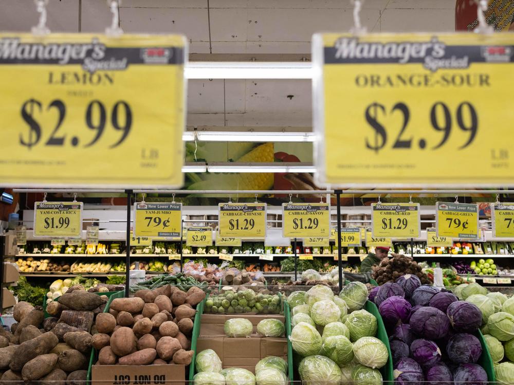 Price tags are displayed at a New York City supermarket  on Dec. 14. Inflation has eased recently, but more evidence is needed to show that price increases are coming down in the long term, Fed Chair Powell said Wednesday.