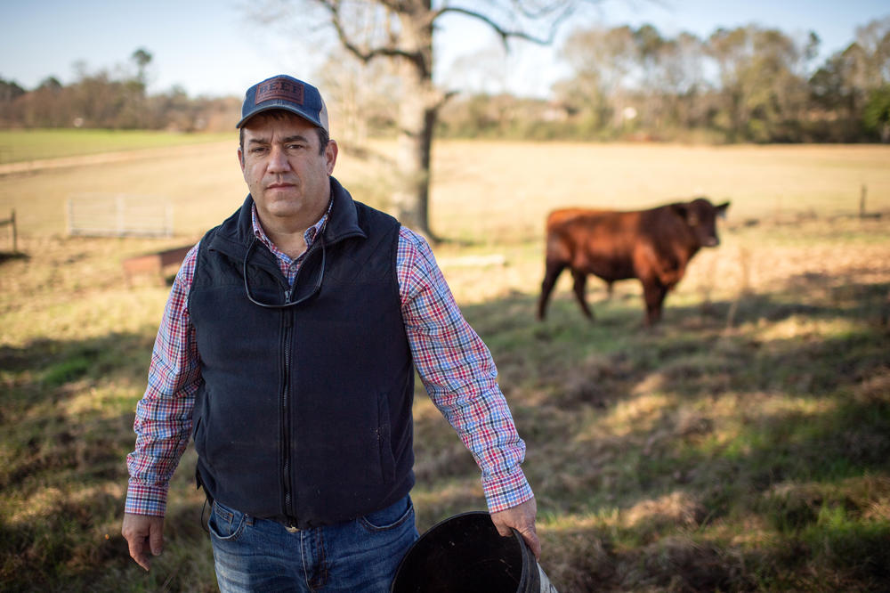 Andy Berry stands for a portrait while feeding cattle on his farm in New Hebron, Miss., on Dec. 16, 2022.