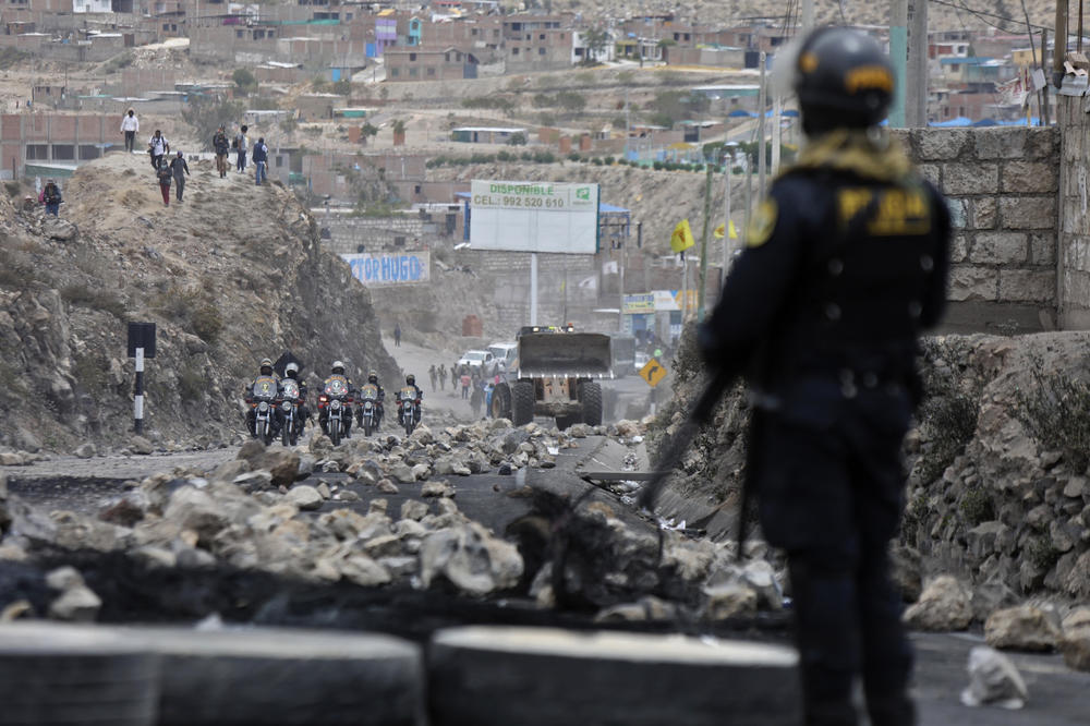 Police arrive to clear debris from a highway, placed by supporters of ousted Peruvian President Pedro Castillo protesting his detention in Arequipa, Peru, on Thursday.