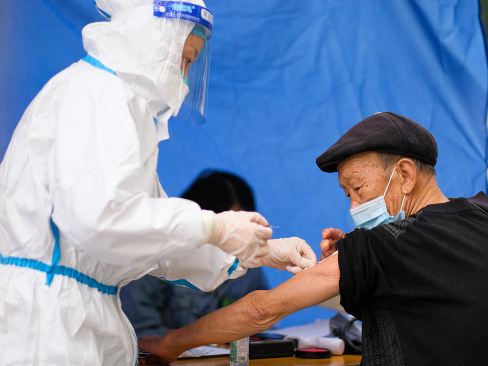 An older adult receives a COVID-19 vaccine at a temporary vaccination site on Dec. 7 in Chongqing, China. Concerns about effectiveness and safety have led to uncertainty about the COVID vaccine, notably among older citizens, whose vaccination rate is relatively low.