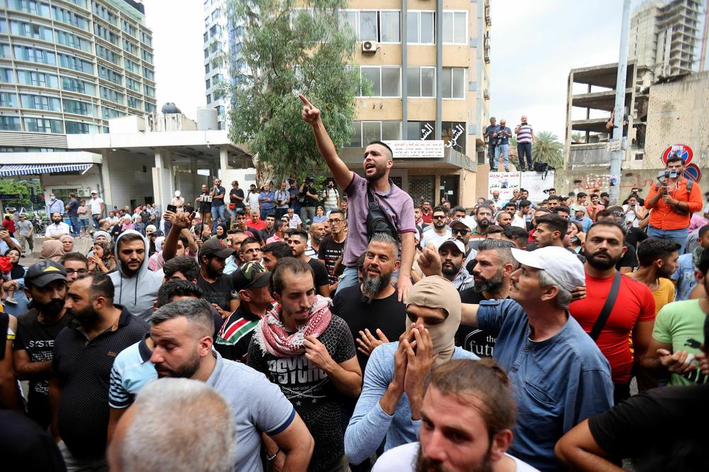 Protesters chant slogans as they gather outside the Justice Palace in Beirut on Sept. 19, demanding the release of two people involved in a bank heist the week before.