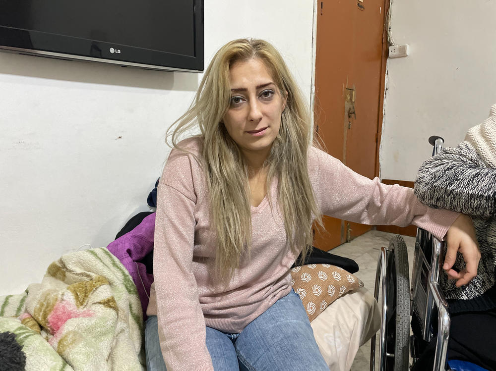 Amina Mohammed, 35, the daughter of Zahra Khaled, sits in her mother's apartment in Tripoli, Lebanon, on Nov. 23. Mohammed says she and her husband and three children will be evicted from her home if she cannot pay the rent.