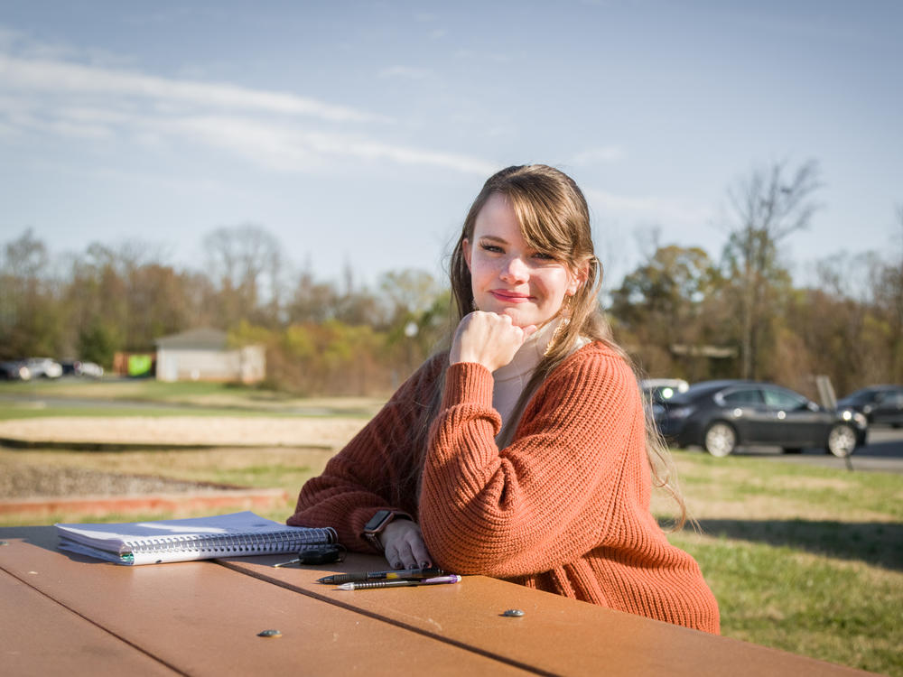 Lauren Overman poses for a portrait at a park close to her home near Greensboro, N.C., on Nov. 21, 2022. Overman will sometimes work virtually from this picnic table as an abortion doula, which she has been doing for over four years. She offers her services virtually and in-person, to people across the U.S., including in states that have banned or severely restricted abortion access.