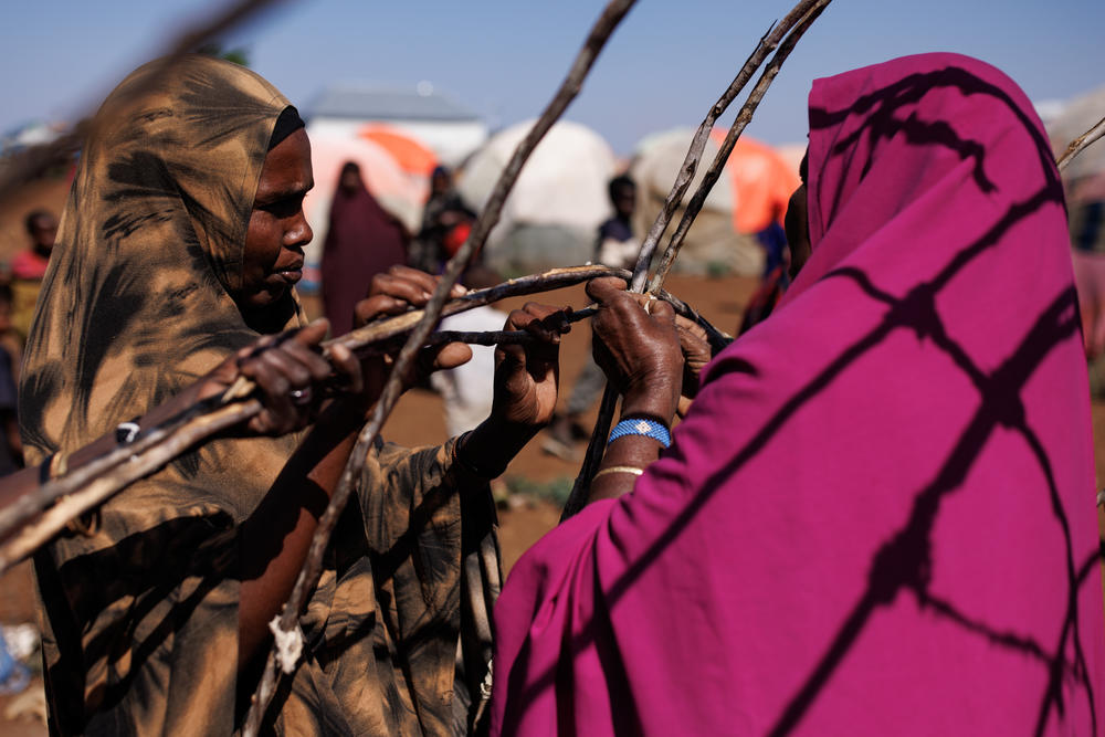 Newly arrived displaced people build a shelter in a camp in Baidoa on Tuesday.